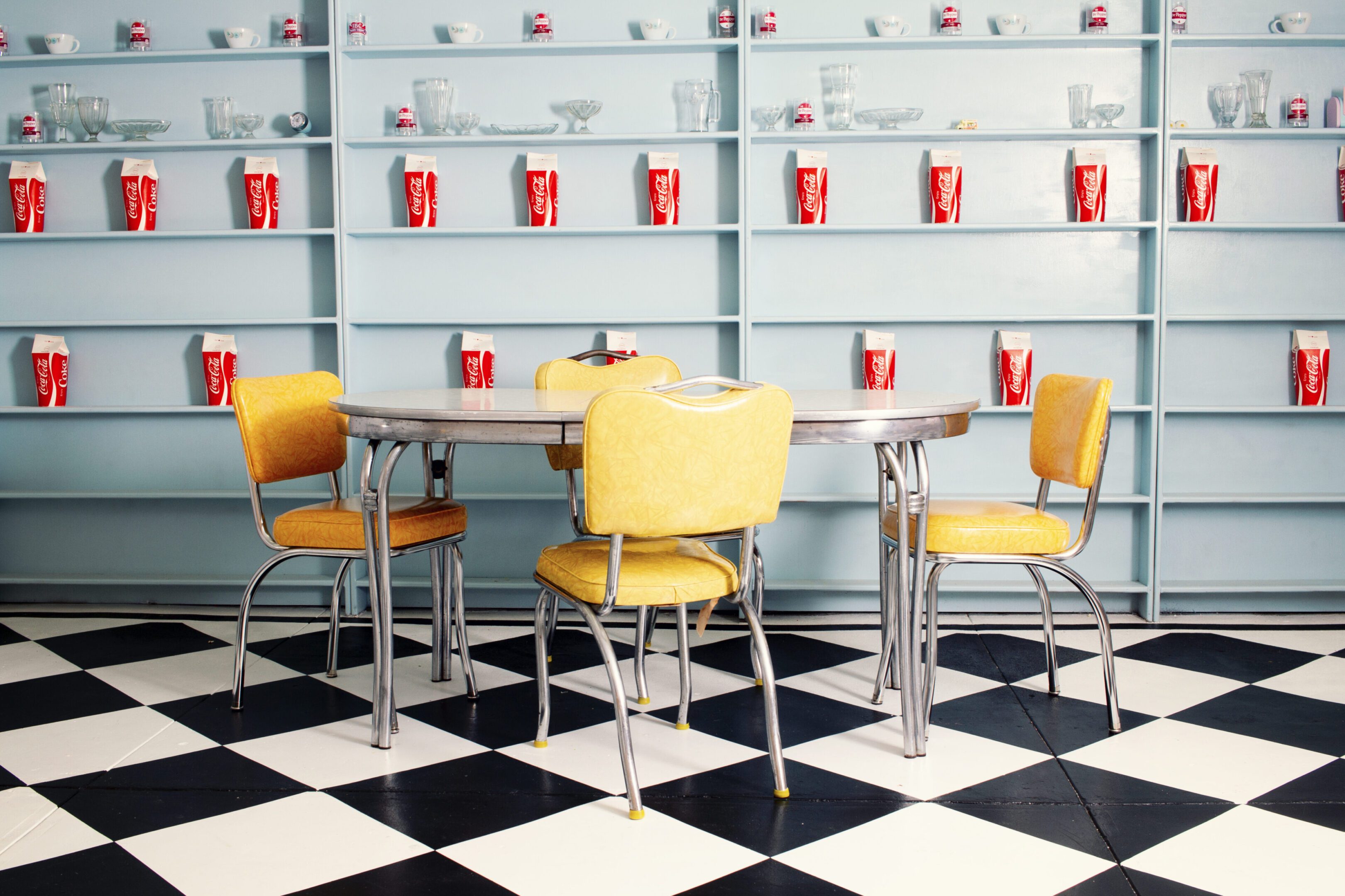 Retro diner table with yellow chairs.