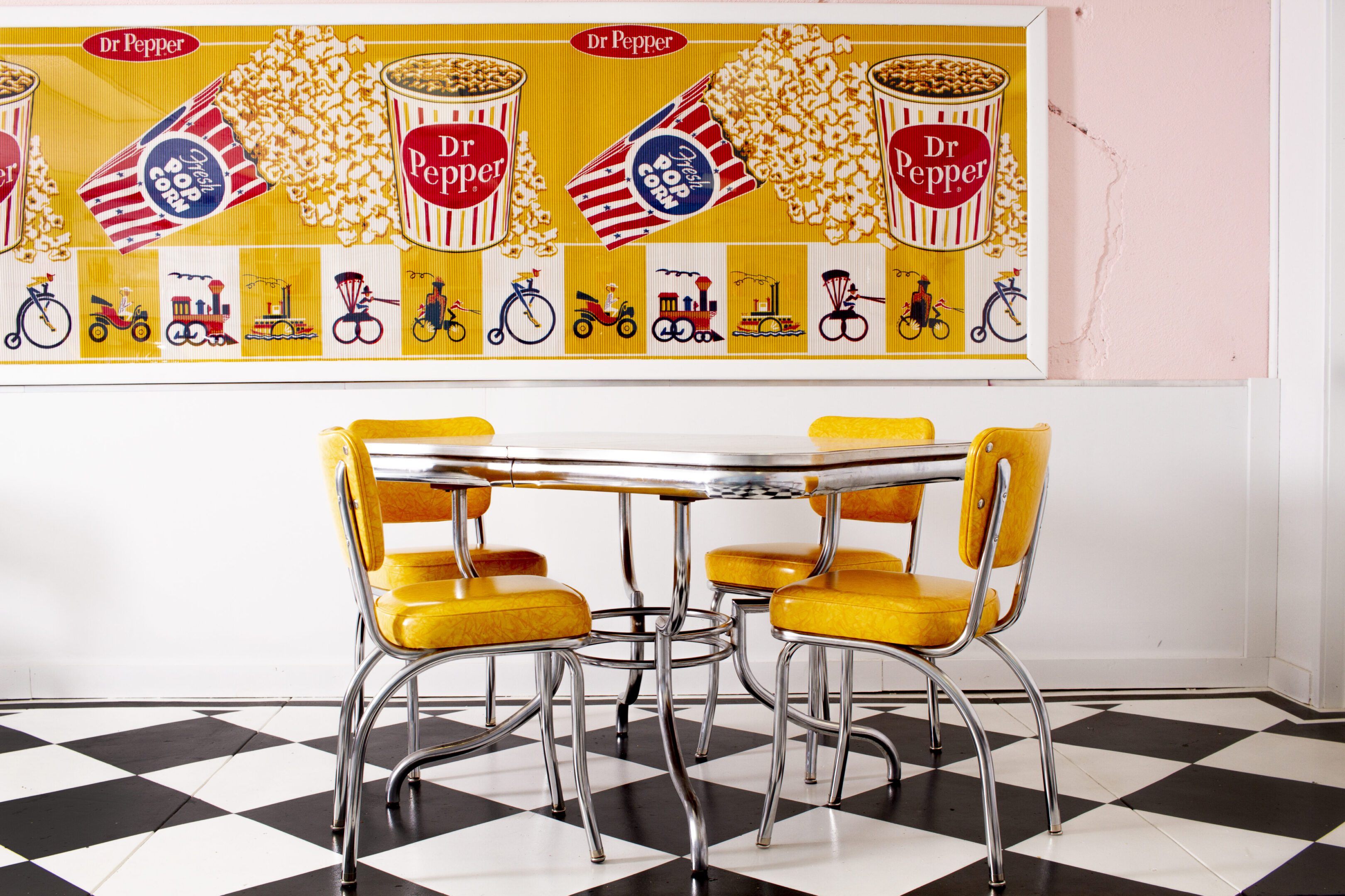 Retro dining area with yellow chairs.