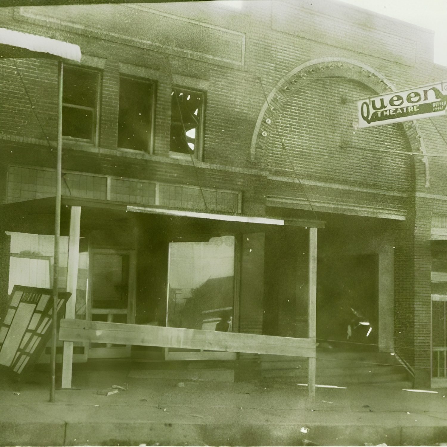 Old brick building with theater sign.