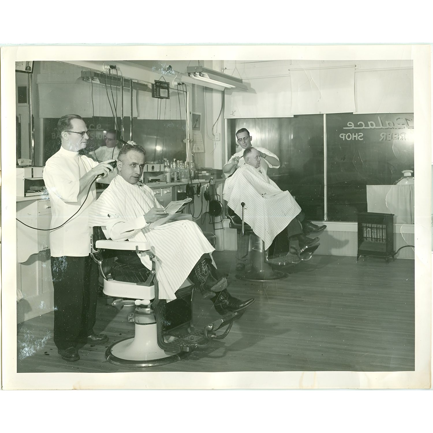 Barber shop with two customers and barbers.