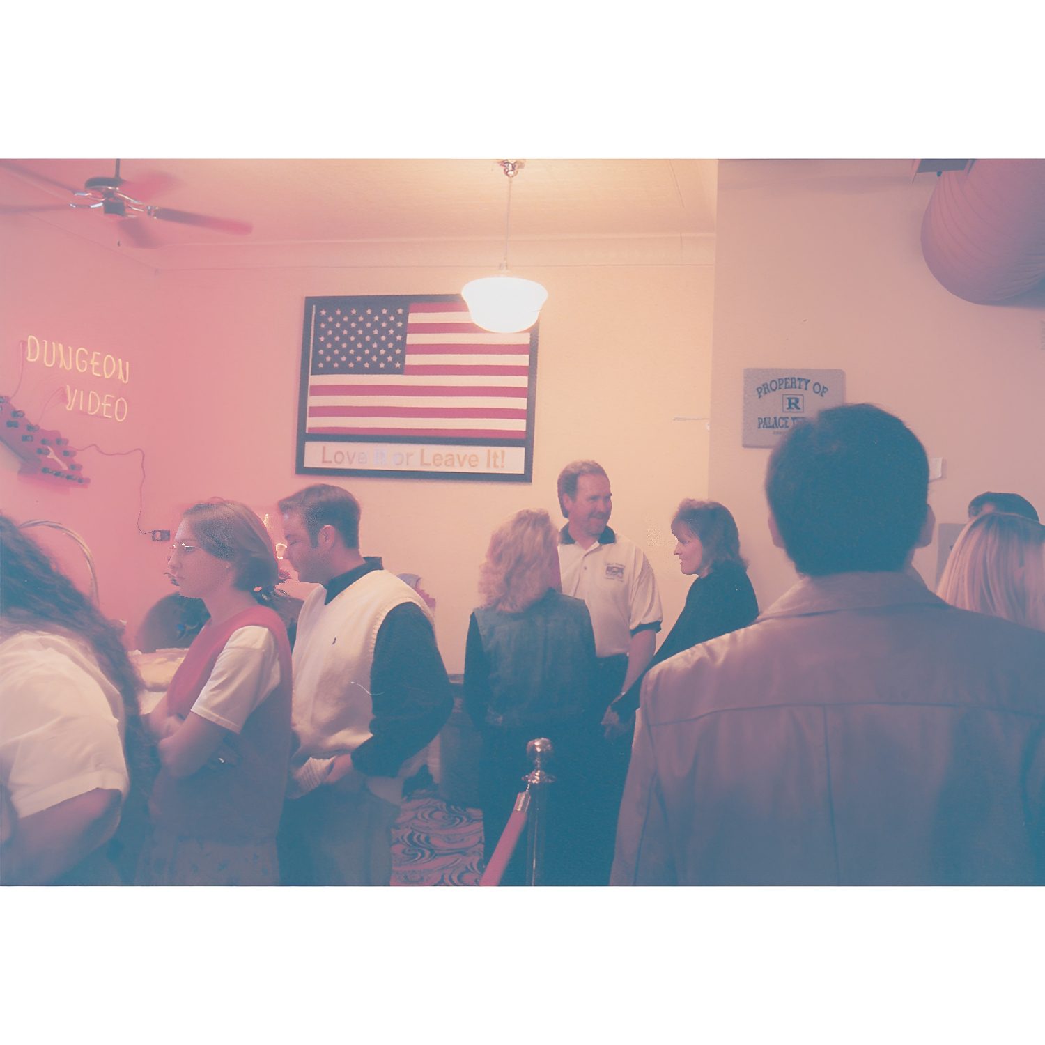 People gathered indoors near American flag.