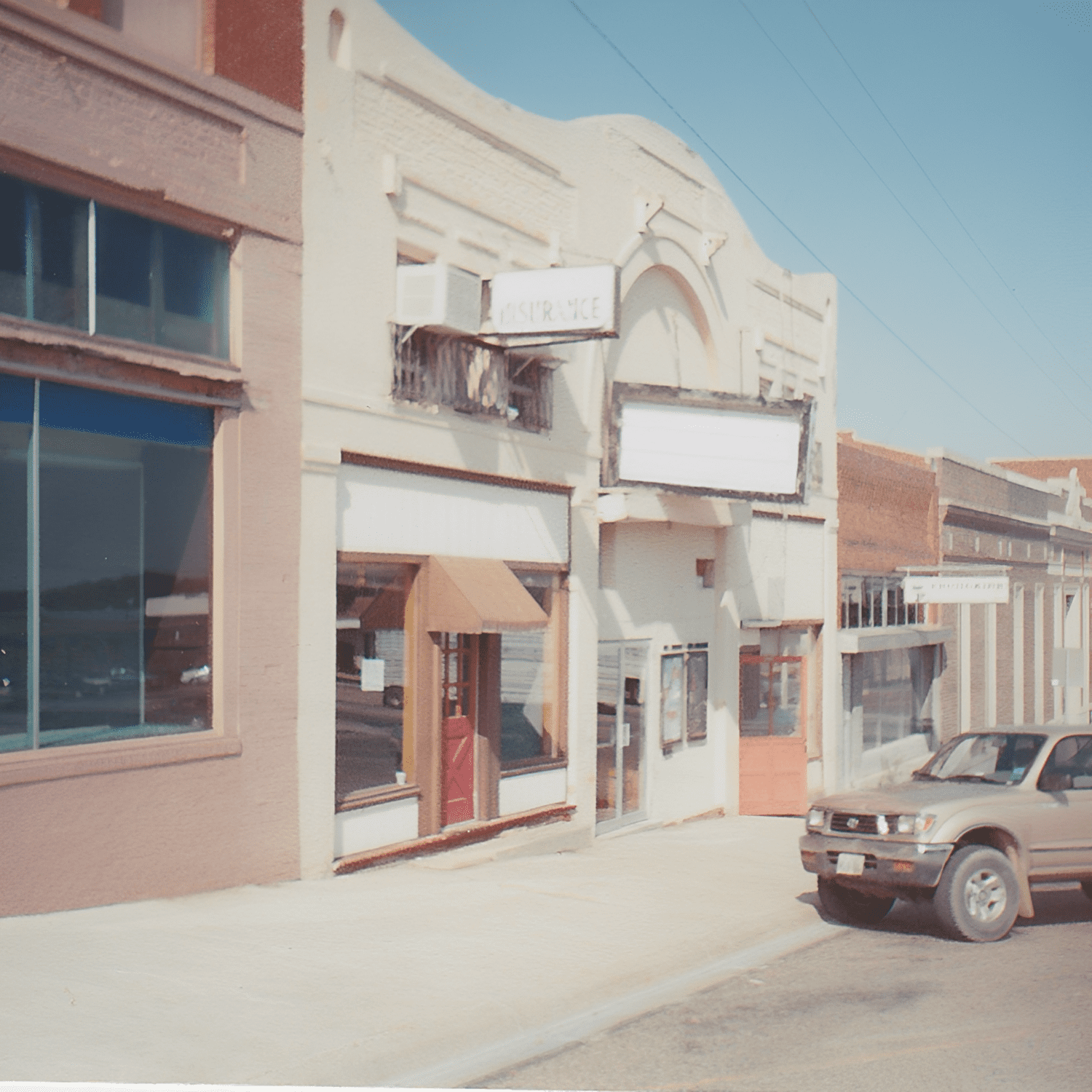 Street with vintage buildings and parked car.