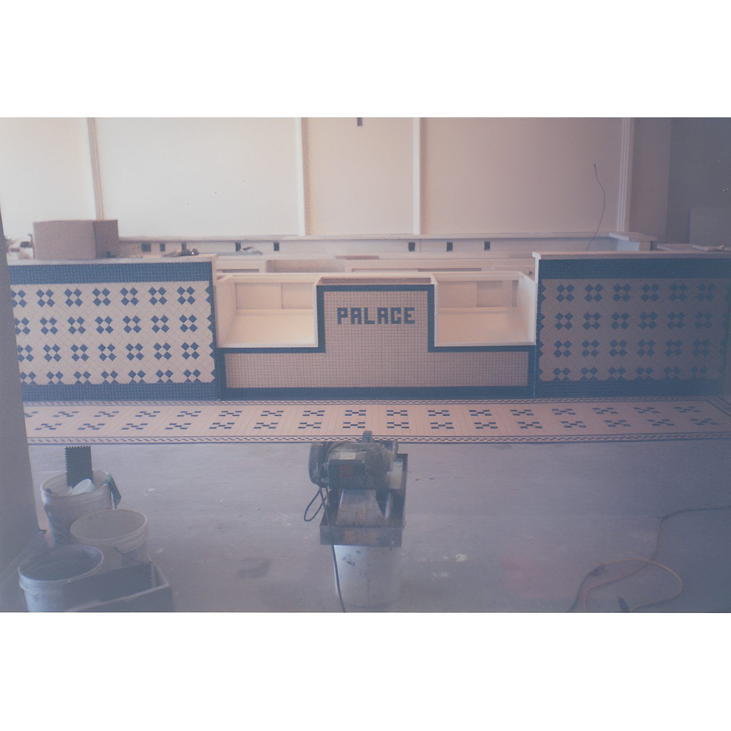Vintage tiled counter with "Palace" sign.