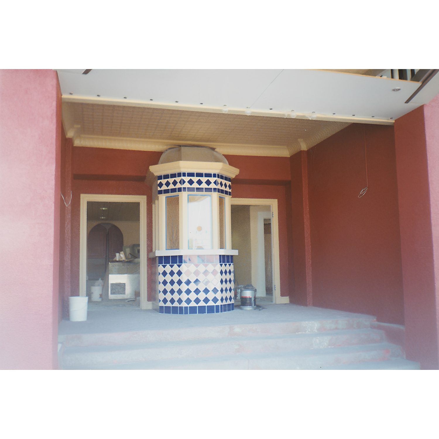 Decorative tiled booth in building entrance.