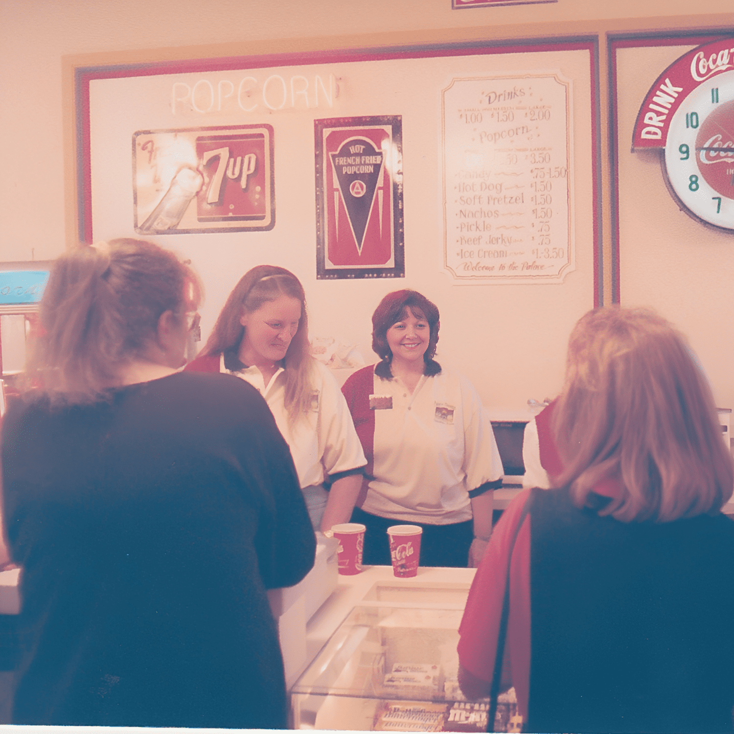 People gathered at a concession stand.