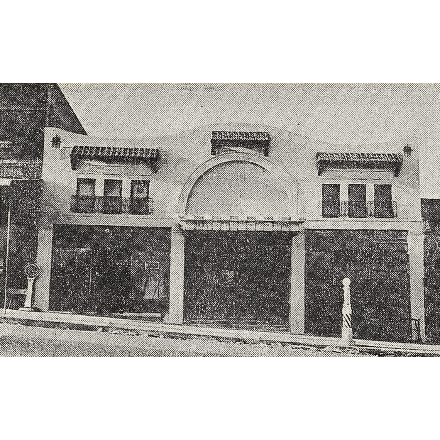 Vintage theater building with arched entrance.