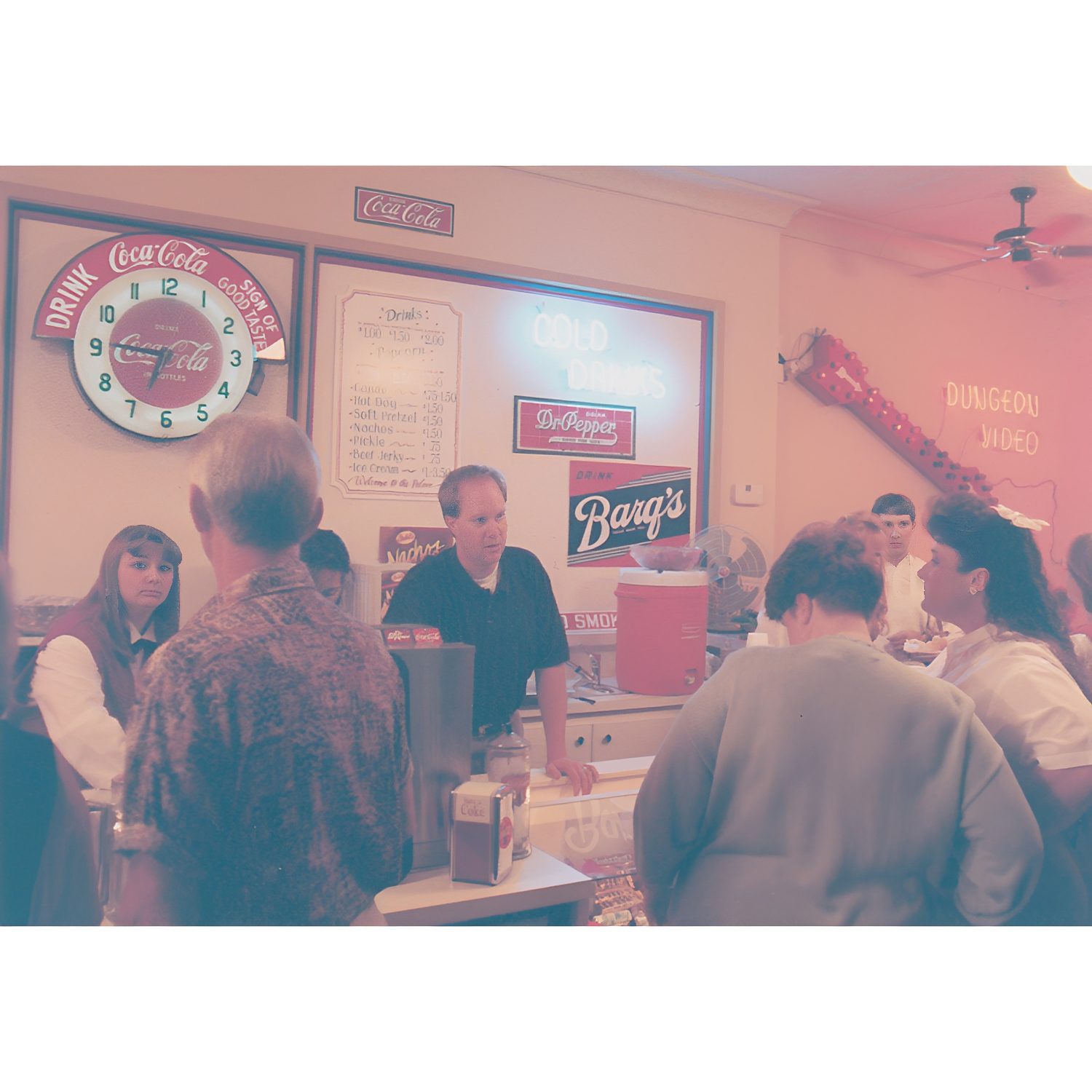 Retro diner with people ordering at counter.
