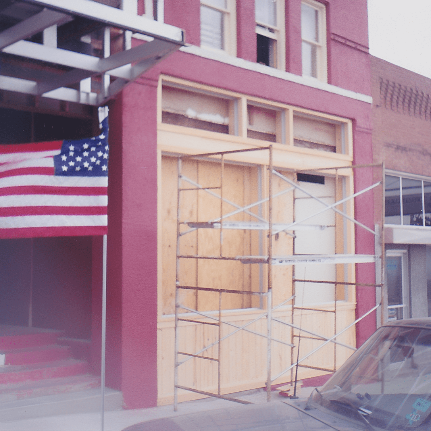 Building under construction with American flag displayed.